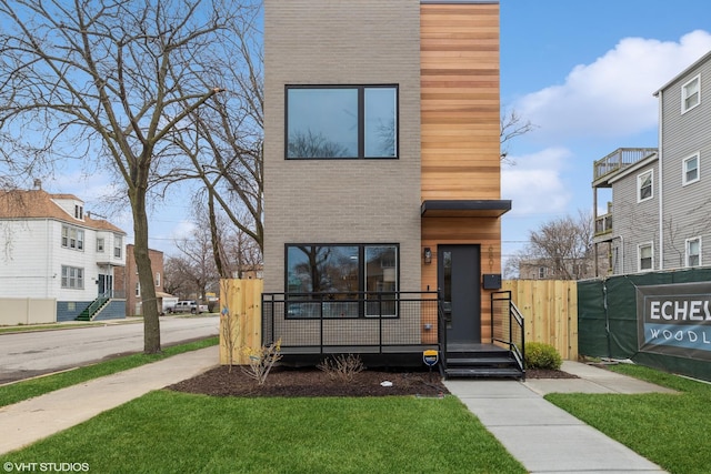 modern home featuring a front lawn