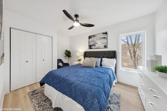 bedroom with multiple windows, a closet, light hardwood / wood-style flooring, and ceiling fan