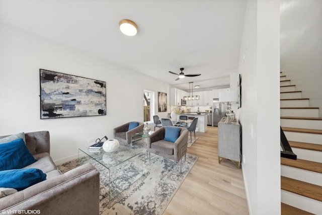 living room featuring ceiling fan and light wood-type flooring