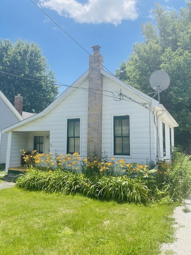 view of property exterior featuring a lawn