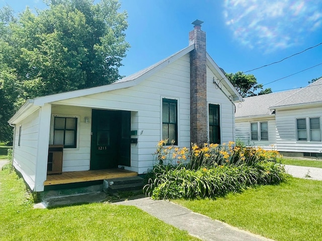 view of front of home with a front lawn and a porch