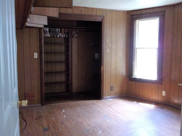 entryway featuring hardwood / wood-style flooring and wood walls