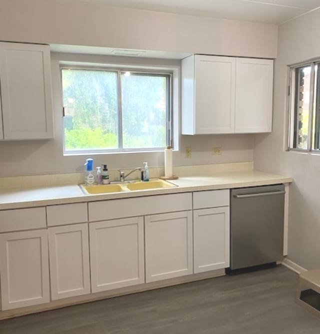 kitchen with dark wood-type flooring, white cabinets, dishwasher, and sink