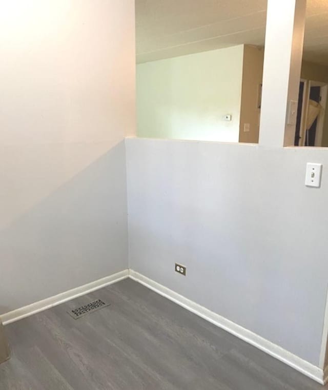 unfurnished room featuring dark hardwood / wood-style flooring