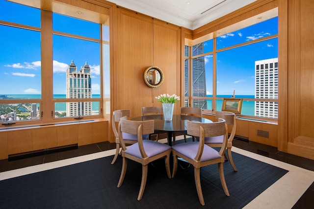 tiled dining room featuring a water view