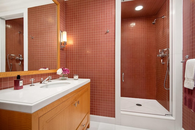 bathroom with a tile shower, tile patterned floors, and vanity