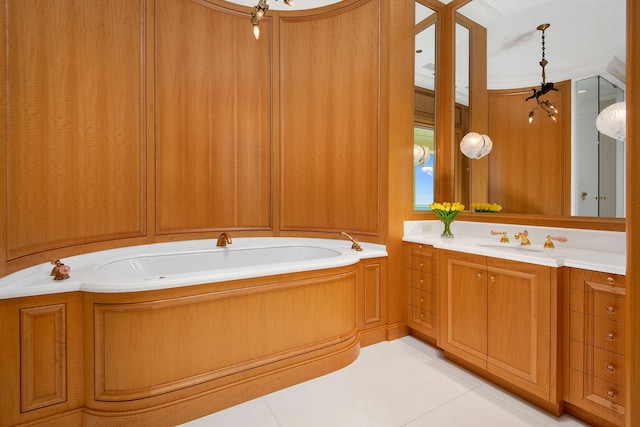 bathroom with a bathtub, vanity, and tile patterned flooring