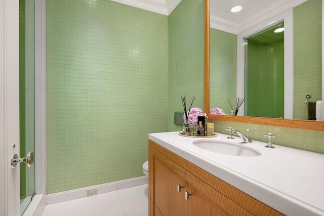 bathroom with toilet, vanity, tile patterned floors, and crown molding