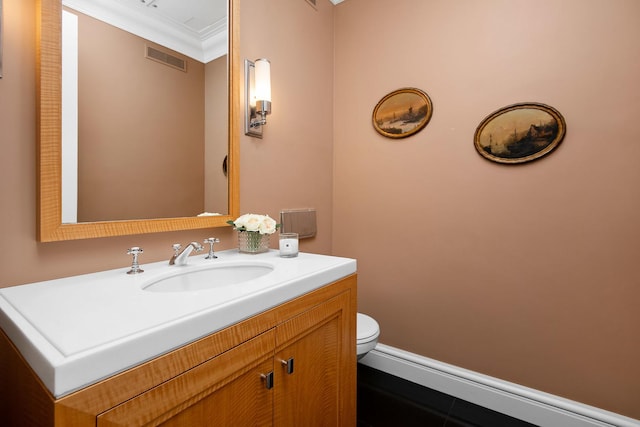 bathroom featuring toilet, vanity, tile patterned flooring, and ornamental molding