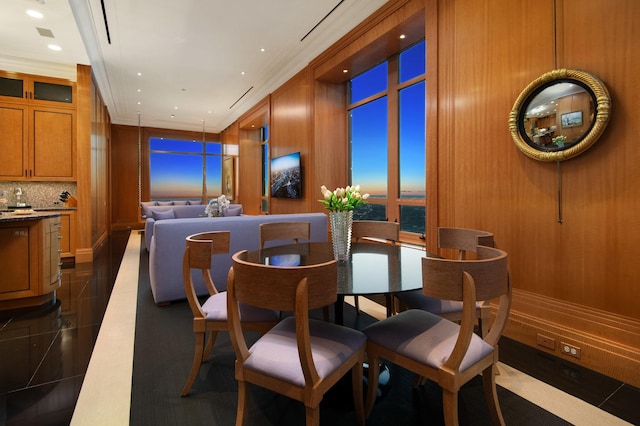 dining room featuring ornamental molding and dark tile patterned floors