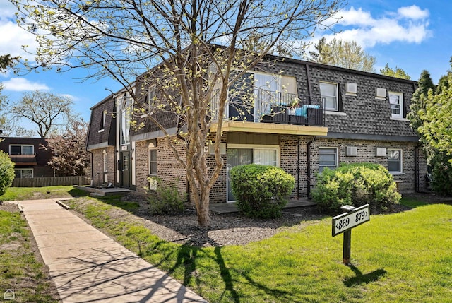 879 Trace Dr Unit 106, Buffalo Grove, IL 60089 - view of front of property with mansard roof, a balcony, and brick siding