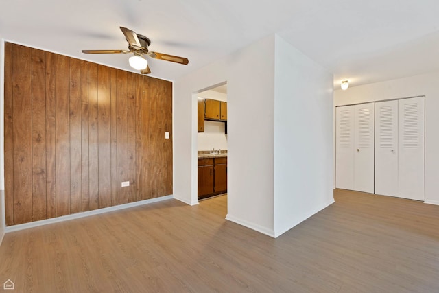 879 Trace Dr Unit 106, Buffalo Grove, IL 60089 - unfurnished living room with ceiling fan, light wood-type flooring, a sink, and baseboards