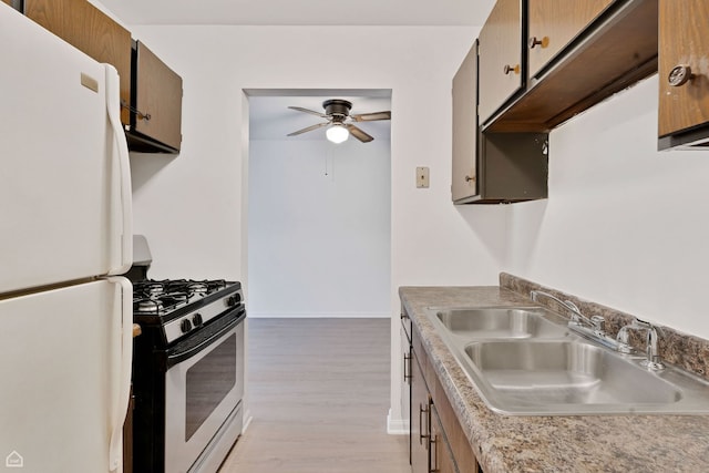879 Trace Dr Unit 106, Buffalo Grove, IL 60089 - kitchen with freestanding refrigerator, stainless steel gas stove, a sink, a ceiling fan, and light wood finished floors