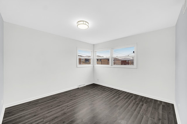 unfurnished room featuring dark hardwood / wood-style flooring