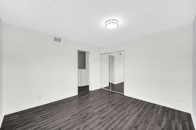 empty room featuring dark hardwood / wood-style flooring