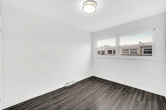 spare room featuring dark wood-type flooring