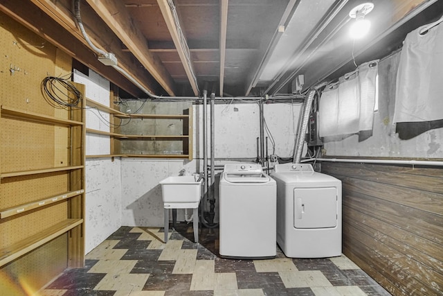 laundry area featuring washing machine and clothes dryer and sink