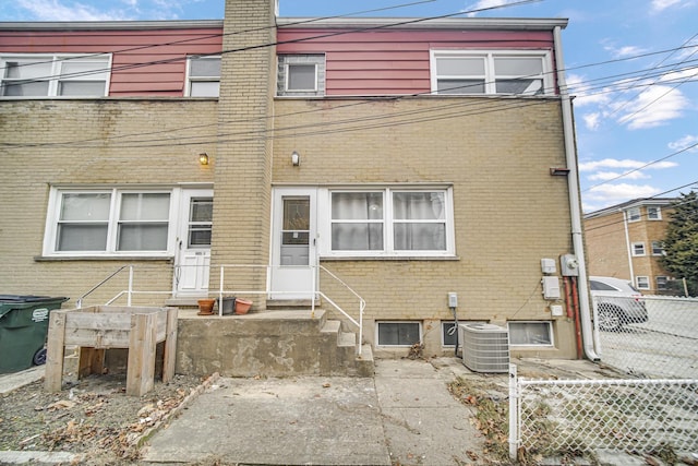 rear view of house featuring central AC unit