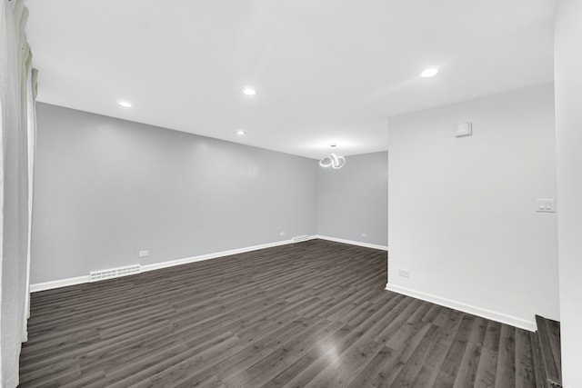 spare room featuring dark hardwood / wood-style floors