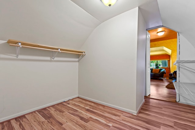 spacious closet with vaulted ceiling and light wood-type flooring