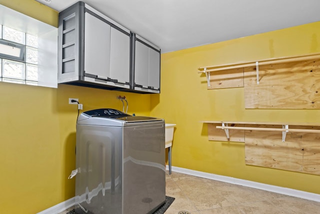 laundry area featuring cabinets and washer / clothes dryer