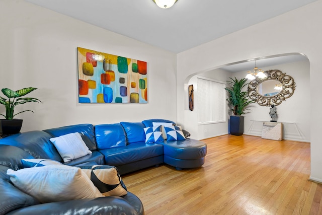 living room featuring a notable chandelier and hardwood / wood-style flooring