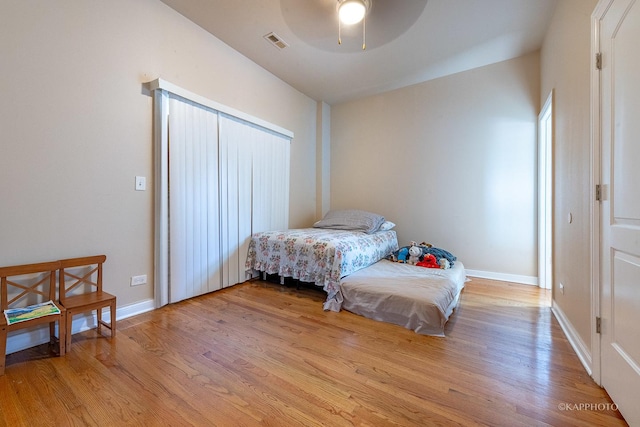 bedroom with ceiling fan and light hardwood / wood-style flooring