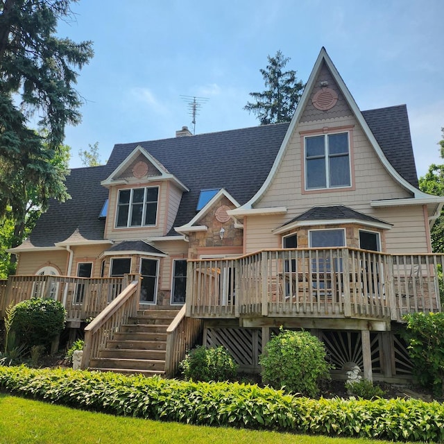 rear view of property with a wooden deck