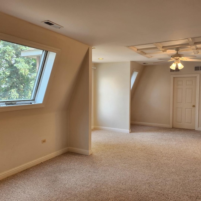 additional living space with ceiling fan and carpet floors