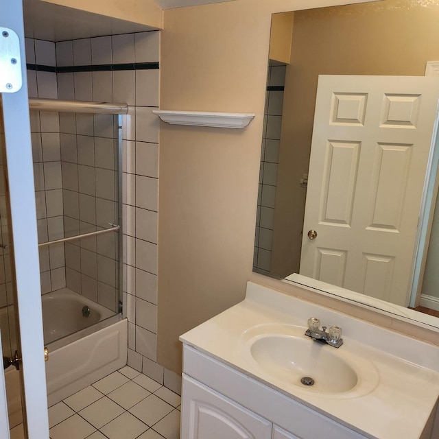 bathroom with tile patterned floors, vanity, and enclosed tub / shower combo