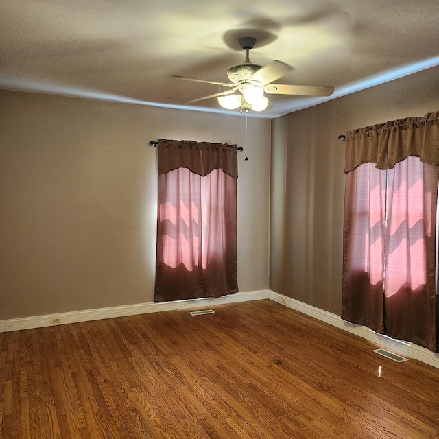 unfurnished room with hardwood / wood-style flooring and ceiling fan