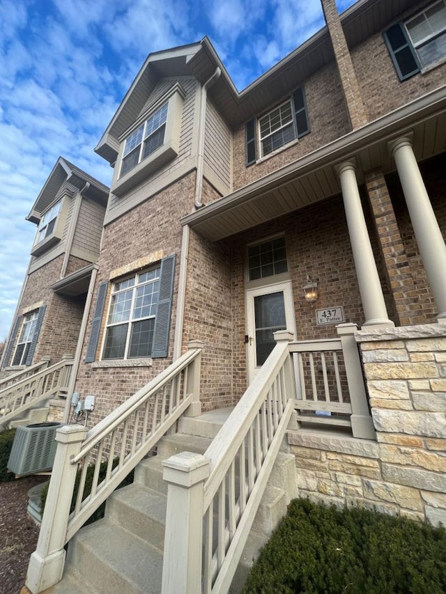 entrance to property featuring central air condition unit and a porch