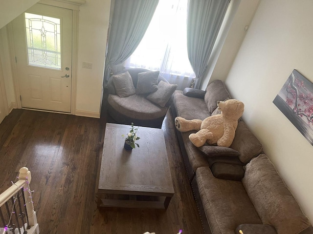 living room featuring plenty of natural light and dark wood-type flooring