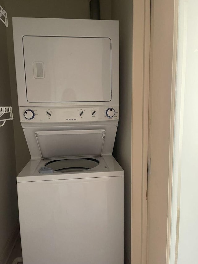 washroom with stacked washer and dryer