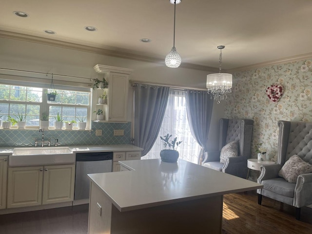 kitchen featuring a center island, sink, hanging light fixtures, stainless steel dishwasher, and dark hardwood / wood-style flooring