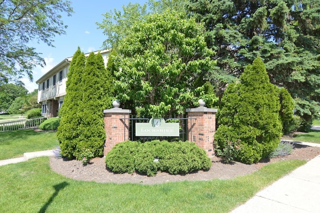 community / neighborhood sign with a lawn