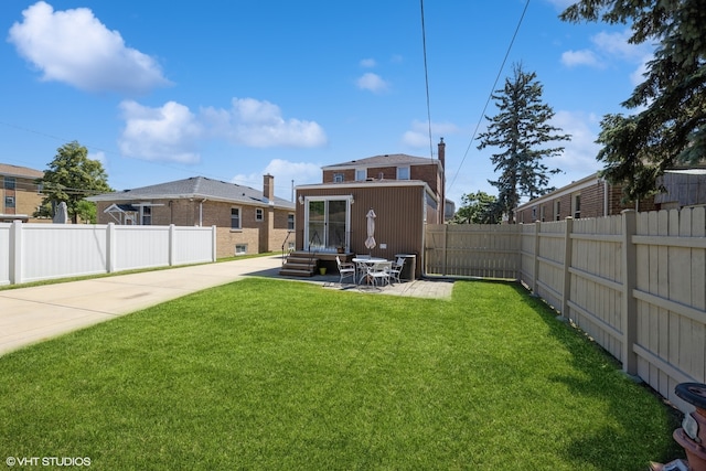 rear view of house with a yard and a patio area