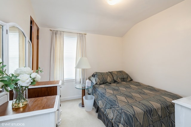 bedroom with carpet and vaulted ceiling