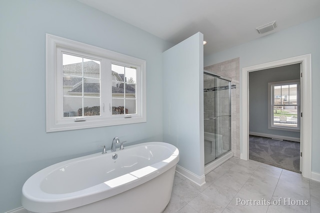 bathroom with tile patterned floors and independent shower and bath