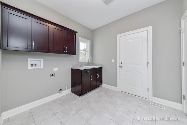 washroom with electric dryer hookup, cabinets, hookup for a gas dryer, sink, and hookup for a washing machine