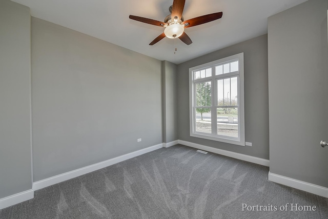 carpeted spare room featuring ceiling fan