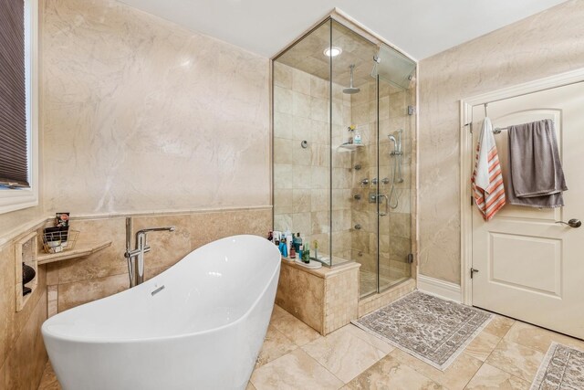 bathroom with shower with separate bathtub, tile walls, and tile floors