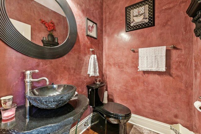 bathroom featuring vanity with extensive cabinet space and toilet