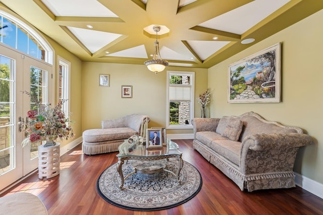 living room with hardwood / wood-style flooring, beam ceiling, french doors, and coffered ceiling