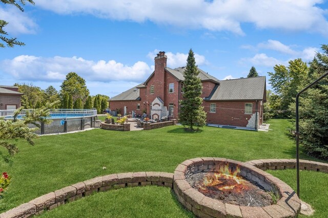 view of yard featuring an outdoor fire pit