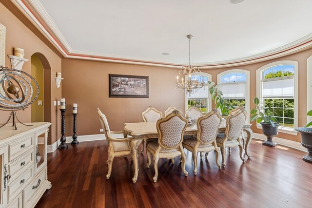 dining space featuring a notable chandelier, dark wood-type flooring, and crown molding