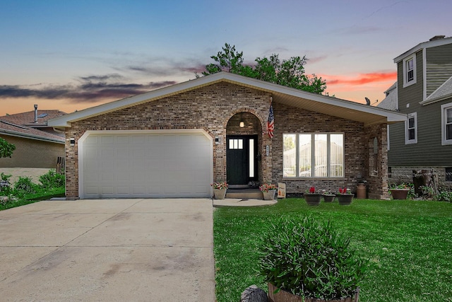 view of front facade with a garage and a yard