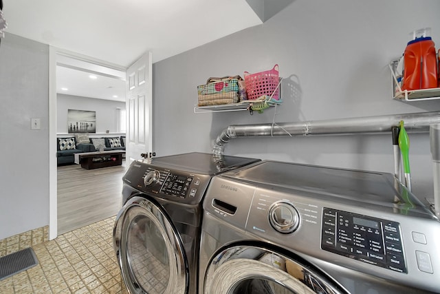 washroom featuring washing machine and clothes dryer