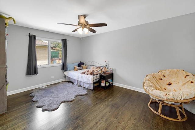 bedroom with ceiling fan and dark hardwood / wood-style flooring