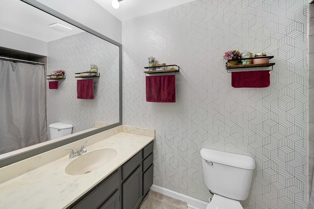 bathroom with tile patterned floors, vanity, and toilet